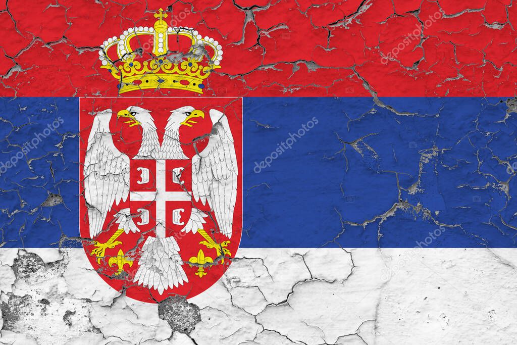 Serbia flag close up grungy, damaged and weathered on wall peeling off paint to see inside surface. Vintage concept.
