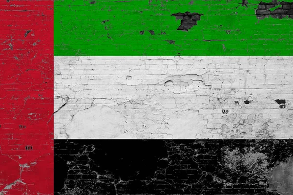 United Arab Emirates flag on grunge scratched concrete surface. National vintage background. Retro wall concept.