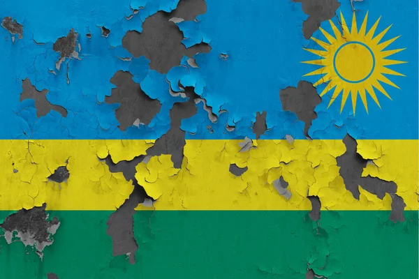 Rwanda flag close up painted, damaged and dirty on wall peeling off paint to see concrete surface. Vintage National Concept.