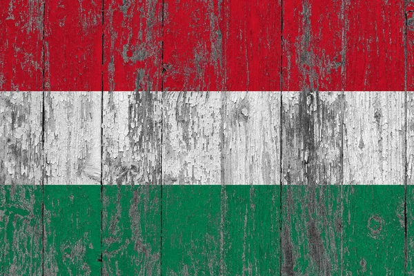 Hungary flag on grunge scratched wooden surface. National vintage background. Old wooden table scratched flag surface.