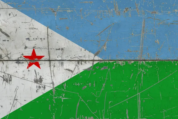 Djibouti flag painted on cracked dirty surface. National pattern on vintage style surface. Scratched and weathered concept.