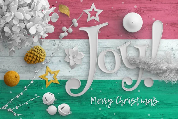 Hungary flag on wooden table with joy text. Christmas and new year background, celebration national concept with white decor.