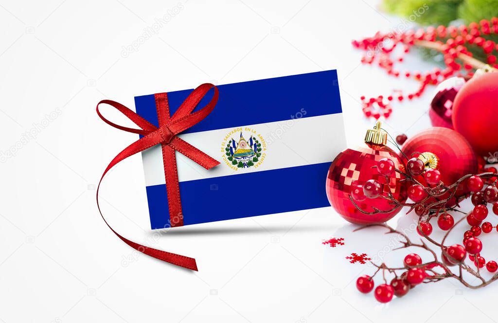 El Salvador flag on new year invitation card with red christmas ornaments concept. National happy new year composition.