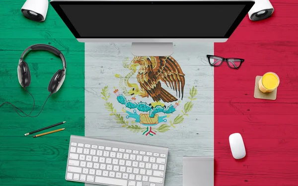 Mexico flag background with headphone,computer keyboard and mouse on national office desk table.Top view with copy space.Flat Lay.