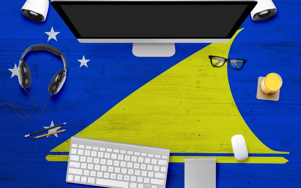 Tokelau flag background with headphone,computer keyboard and mouse on national office desk table.Top view with copy space.Flat Lay.