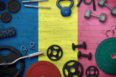 Çad spor ve spor konsepti. Ulusal arkaplanda demir çubuk bulunan ağır ağırlık plakalarının üst görünümü.