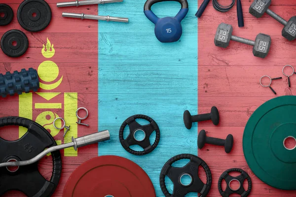 Moğolistan spor ve fitness konsepti. Ulusal arkaplanda demir çubuk bulunan ağır ağırlık plakalarının üst görünümü.