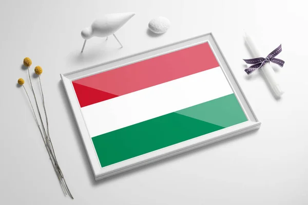 Hungary flag in wooden frame on table. White natural soft concept, national celebration theme.