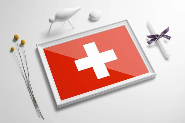 Switzerland flag in wooden frame on table. White natural soft concept, national celebration theme.