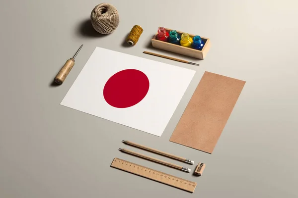 Japan calligraphy concept, accessories and tools for beautiful handwriting, pencils, pens, ink, brush, craft paper and cardboard crafting on wooden table.
