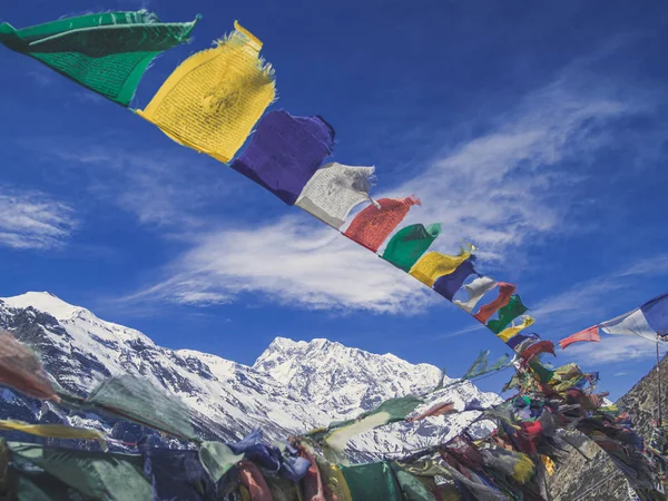 Buddhist prayer flags with Gangapurna mountain backround