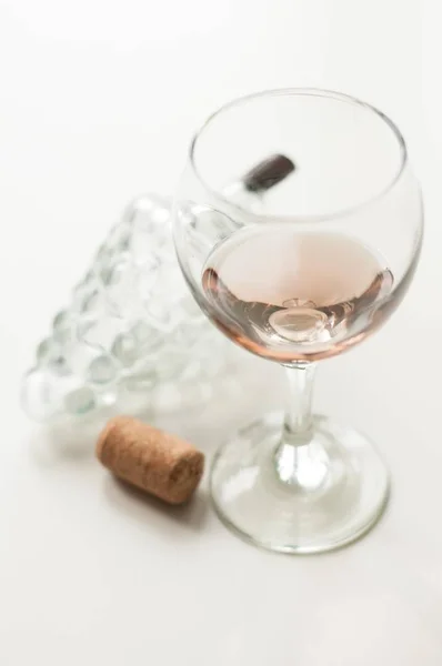 Transparent glass of wine. Pink wine. Festive mood. Alcohol for a group of friends. Delicious drink. Light background. Noble drink. Lavender and rose wine. Wine from lavender — Stock Photo, Image