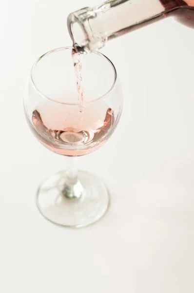 Transparent glass of wine. Pink wine. Festive mood. Alcohol for a group of friends. Delicious drink. Light background. Noble drink. Lavender and rose wine. Wine from lavender — Stock Photo, Image
