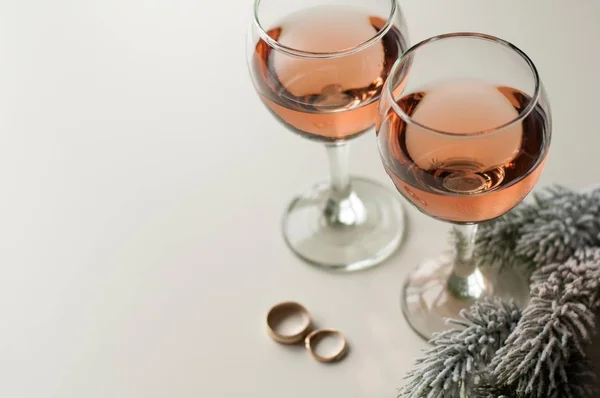 Transparent glass of wine. Pink wine. Festive mood. Alcohol for a group of friends. Delicious drink. Light background. Noble drink. Lavender and rose wine. Wine from lavender