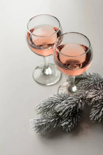 Transparent glass of wine. Pink wine. Festive mood. Alcohol for a group of friends. Delicious drink. Light background. Noble drink. Lavender and rose wine. Wine from lavender