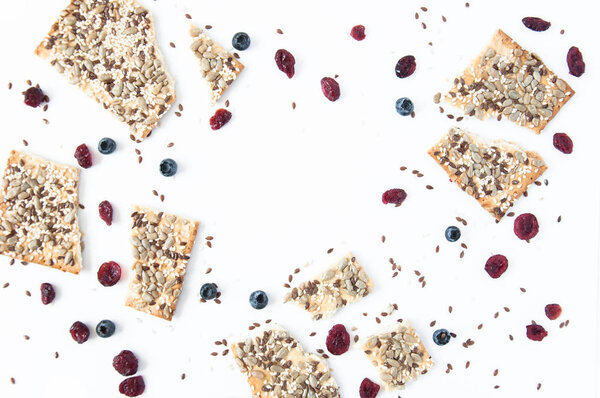 White background with grain cookies fresh blueberries, dried cranberries. Useful snack, proper nutrition. Healthy breakfast. Food for vegans.