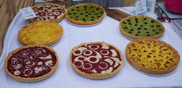 pies with mushrooms, olives, raspberry, tomato sauce, cheese on a table. Pizza ingredients. hot pies. Top view. copy space