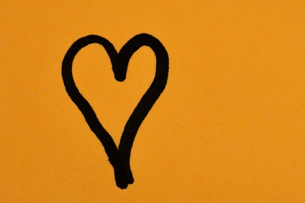 heart drawing on orange background