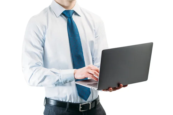 白い背景のネクタイをしたライトシャツの男がノートパソコンのキーボードで入力しています ロイヤリティフリーのストック画像