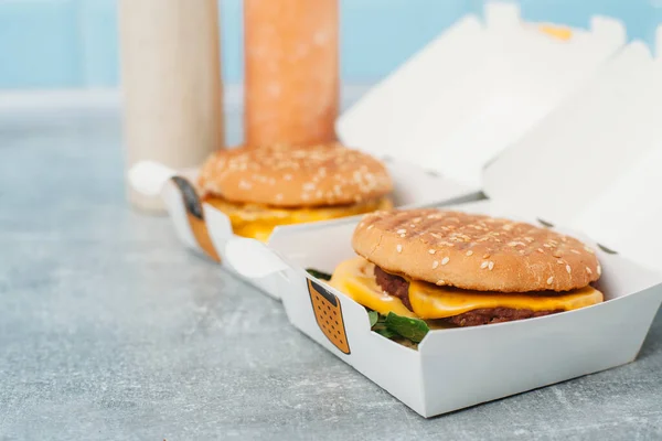 Vegan burgers in a paper box with food delivery.Natural juice on the background.