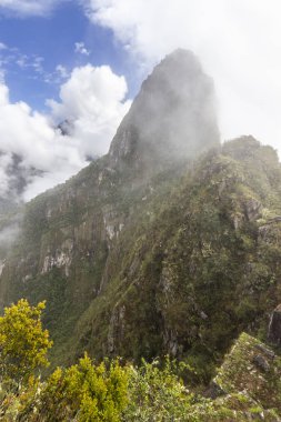 Huayna Picchu sis bulutları geri çekilme sırasında arasında bizim göz önünde görünür. Etkileyici vadiler ve dağ dik duvarlar İnka İmparatorluğu, Peru, Güney Amerika'nın eski şehri çevreleyen