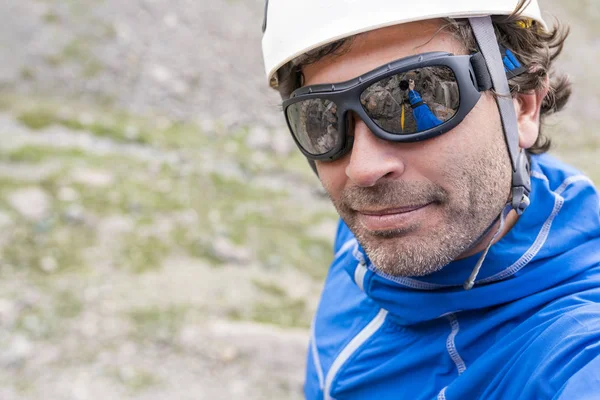 Face expressions while a climber climb a big wall inside the Andes, an amazing adventure. Smile on his faces while going to the mountain summit. Cajon del Arenas (Arenas Valley), Chile