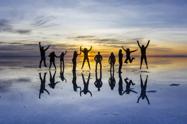 People reflections at Uyuni saltflats. One of the most amazing things that a photographer can see. The sunrise over an infinite horizon with the Uyuni salt flats making a wonderful mirror to infinity