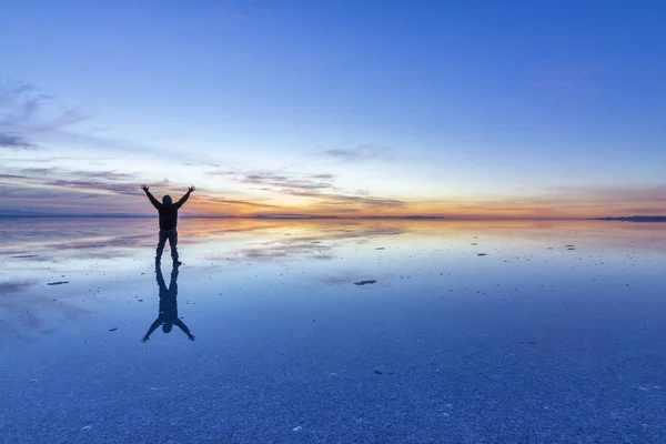 People reflections at Uyuni saltflats. One of the most amazing things that a photographer can see. The sunrise over an infinite horizon with the Uyuni salt flats making a wonderful mirror to infinity