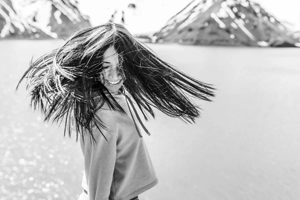 Girl with messy windy hair at Santiago de Chile city in Andes mountains