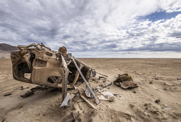 Still visible the effects of the 2015 flooding in North Chile at Chaaral beach. A car remains abandoned above the ground, rusty by the aggressive environment in the outdoors at Atacama Desert, Chile