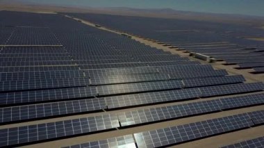 Atacama Çölü'nde kuru topraklar boyunca yüzlerce güneş enerjisi modülleri veya paneller satır hava görüntüleri, Şili. Büyük Fotovoltaik Pv Bitki görünümü bir hava drone noktasından çölün ortasında