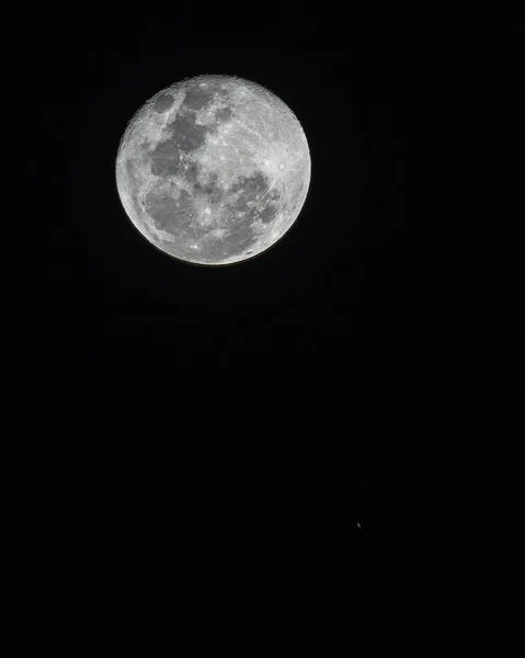 An amazing astronomy event, Saturn covered by the Moon surface awe night sky view from Santiago, Chile, polluted skies with an advanced amateur telescope. Saturn and its rings eclipse by the Moon