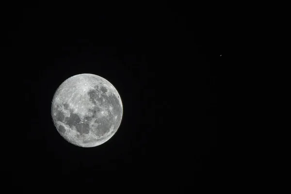 An amazing astronomy event, Saturn covered by the Moon surface awe night sky view from Santiago, Chile, polluted skies with an advanced amateur telescope. Saturn and its rings eclipse by the Moon