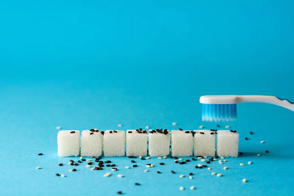 Brushing Teeth Toothbrush Cleans Dirt Teeth Sugar Cubes Sesame Seeds — Stock Photo, Image