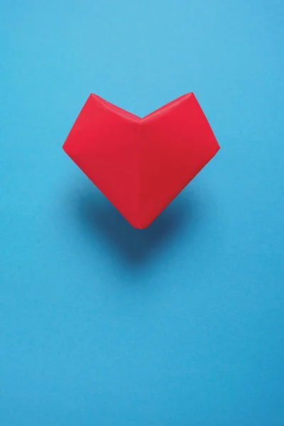 Heart health or Valentine\'s day concept. Red paper heart. Origami. Paper cut style. Toned