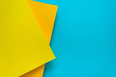 Mavi ve sarı pastel renk arka plan papered. Birim geometrik düz yatıyordu. Üstten görünüm. Kopya alanı