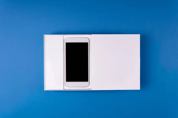 Feminine Hands Holding White Gift Box Smart Phone Blue Paper — Stock Photo, Image