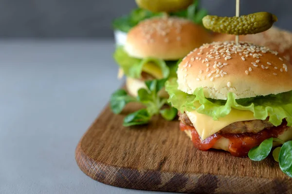 Tasty Homemade Burgers Lettuce Ketchup Cheese Chicken Gray Wooden Background — Stock Photo, Image