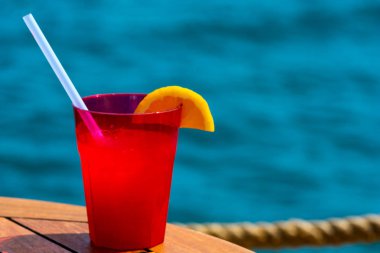 Bulanık deniz arka plan ile ahşap meyve kokteyli. Seyahat ve dinlenme konsepti