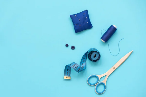 青い背景に糸 はさみ ファブリック ボタン 縫製テープを備えた縫製アクセサリー トップビュー フラットレイ — ストック写真