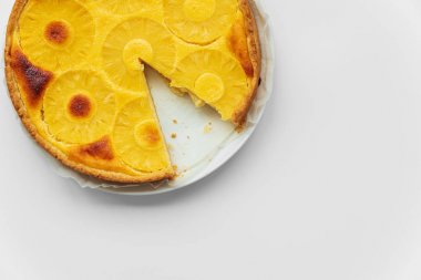 Beyaz masada baş aşağı ananas kek dilimlenmiş. Yaz tropikal tatlısı. Üst te. Kopyalama alanı