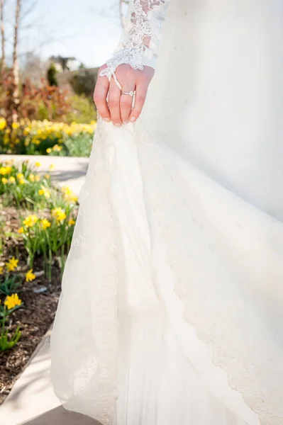 Bride Holds Train Her Dress She Walks Garden Flowers — Stock Photo, Image