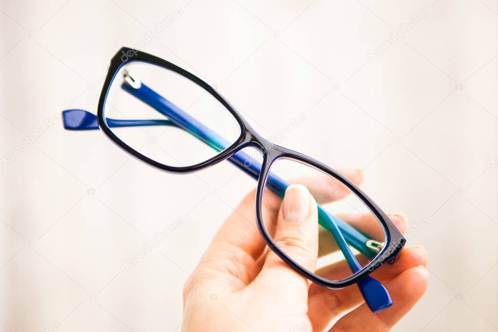 Glasses (eyewear)  in blue frame in hand