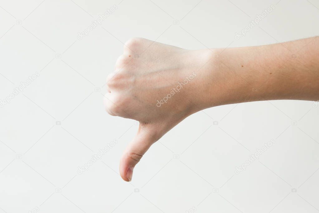 Sign DISLIKE with finger on white background