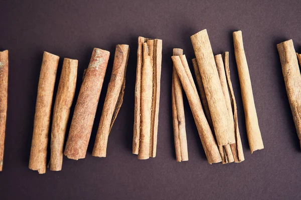 Cinnamon sticks on brown background