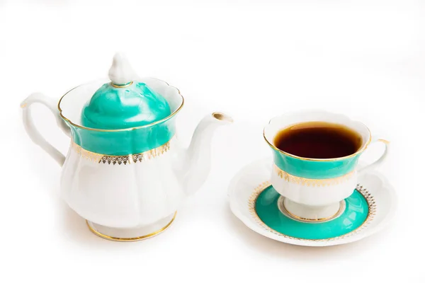 Green indian cup of tea and kettle on white background. Isolated on white. Indian dishes