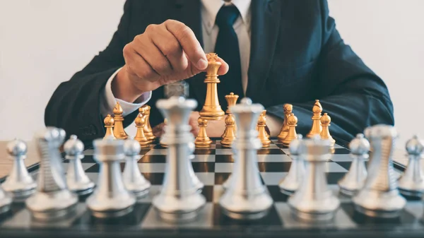 Businessman leadership playing chess and thinking strategy plan about crash overthrow the opposite team and development analyze for successful of corporate.