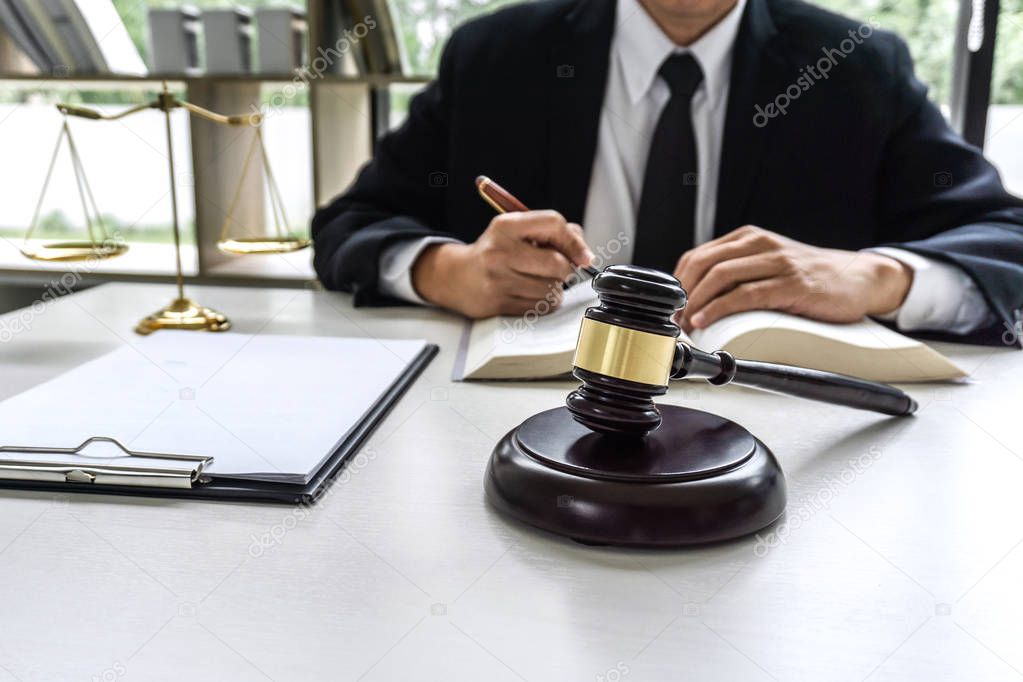 Law, lawyer attorney and justice concept, male lawyer or notary working on a documents and report of the important case in the workplace office.