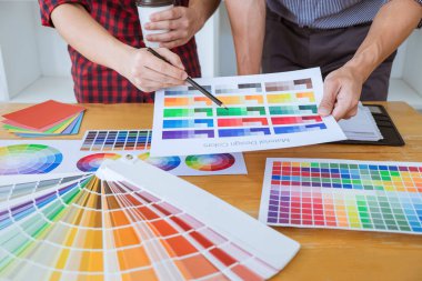 Toplantı yaratıcı grafik tasarımcı takım seçimi seçim yeni projede çalışan iş araçları ve aksesuarları ile tablet renk ve grafik çizim.