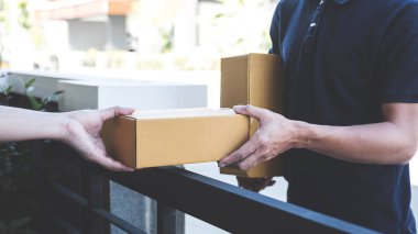 Posta teslimatçı parsel kutusunu kabul alıcı, Genç sahibine vererek karton kutular paket--dan yazı Sevkiyat, teslimat ve kurye hizmeti zihin kavramı Anasayfa.